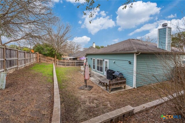 2154 Hidden Mdw, New Braunfels, TX 78130 - rear view of house featuring a fenced backyard and a chimney