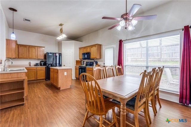 dining space featuring sink, plenty of natural light, ceiling fan, and light wood-type flooring