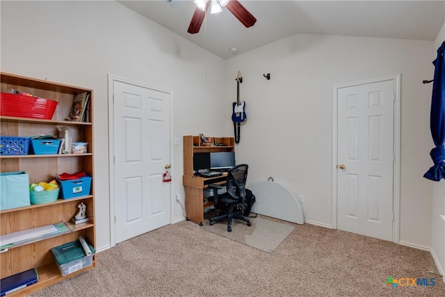 carpeted home office with lofted ceiling and ceiling fan