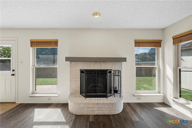 1007 Judy Ln, Copperas Cove, TX 76522 - living room with wood finished floors, a fireplace, healthy amount of natural light, and a textured ceiling