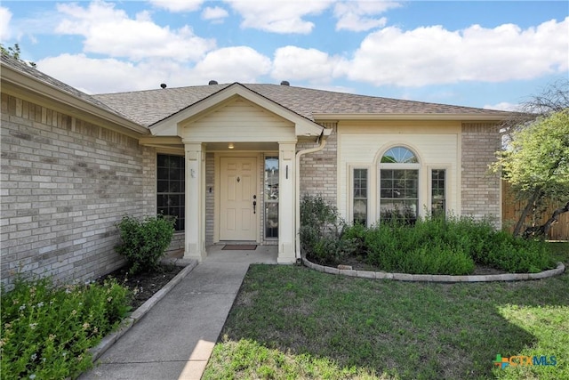 1007 Judy Ln, Copperas Cove, TX 76522 - entrance to property featuring brick siding, a yard, and roof with shingles