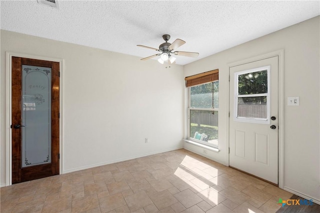 1007 Judy Ln, Copperas Cove, TX 76522 - spare room featuring a ceiling fan, a textured ceiling, and stone finish flooring