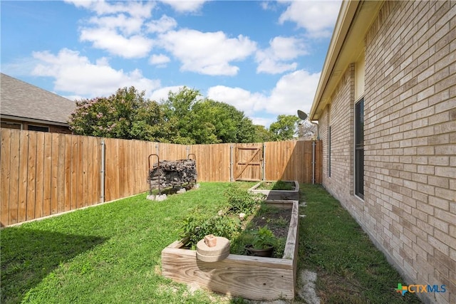 1007 Judy Ln, Copperas Cove, TX 76522 - fenced backyard with a garden and a gate