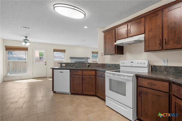 1007 Judy Ln, Copperas Cove, TX 76522 - kitchen with white appliances, under cabinet range hood, a peninsula, ceiling fan, and a textured ceiling