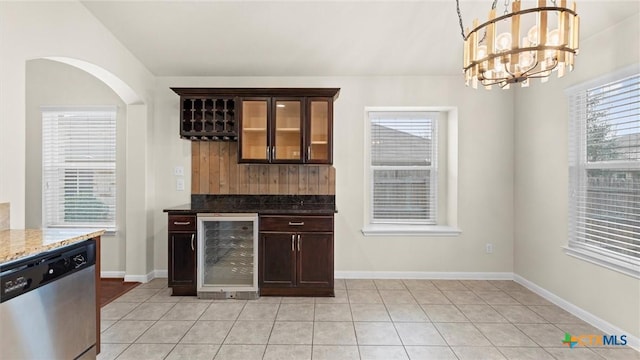 kitchen with pendant lighting, wine cooler, stainless steel dishwasher, light tile patterned floors, and dark brown cabinetry