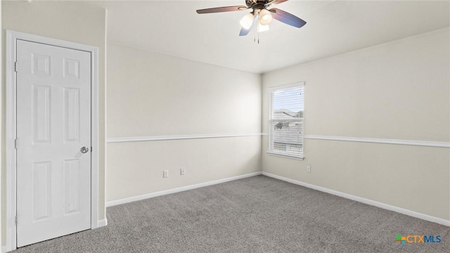 carpeted spare room featuring ceiling fan