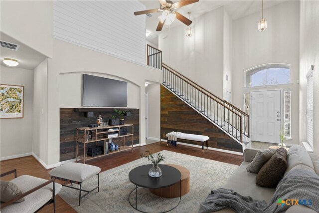 kitchen featuring appliances with stainless steel finishes, pendant lighting, decorative backsplash, light tile patterned floors, and light stone countertops