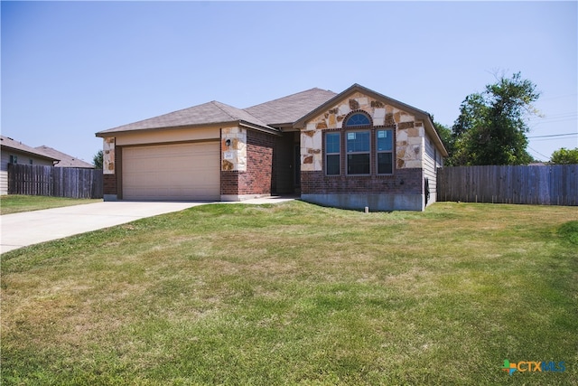 ranch-style home with a garage and a front yard