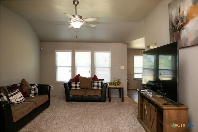 living room with ceiling fan, light carpet, and vaulted ceiling