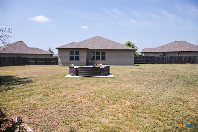 back of property with a lawn and a patio area