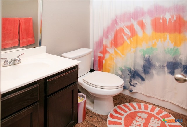 bathroom featuring hardwood / wood-style floors, vanity, toilet, and a shower with shower curtain