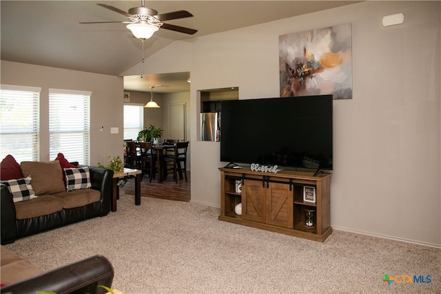 carpeted living room featuring ceiling fan and vaulted ceiling