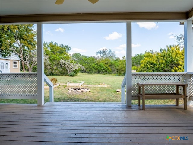 wooden deck with a lawn