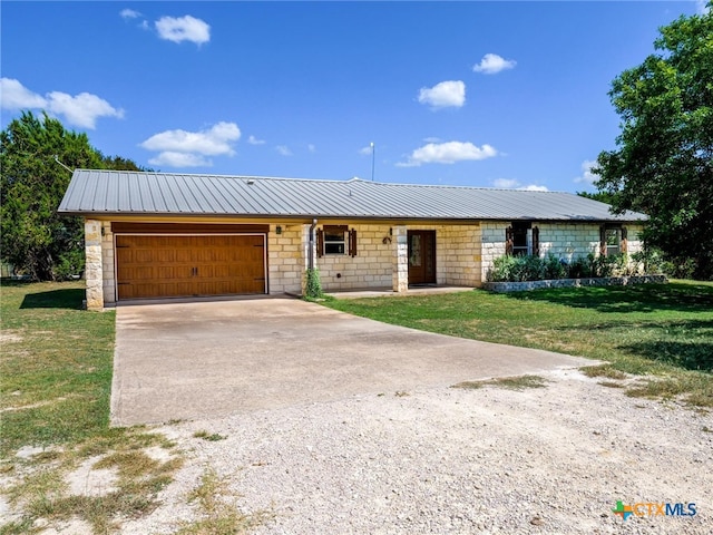 ranch-style house featuring a garage and a front yard