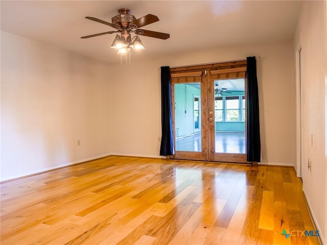 empty room featuring french doors, light hardwood / wood-style flooring, and ceiling fan