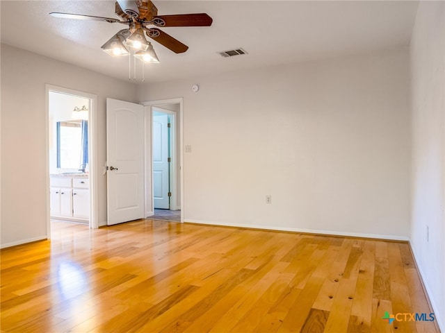 spare room with wood-type flooring and ceiling fan