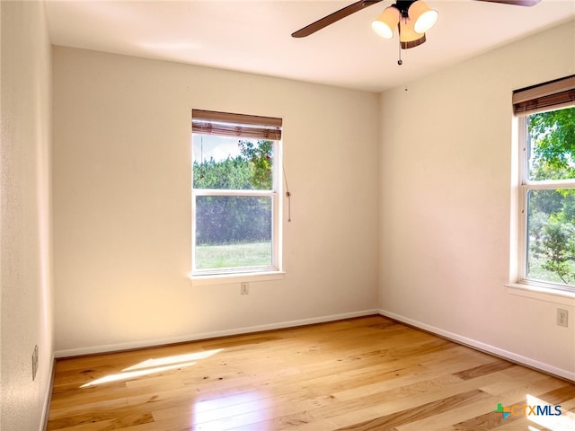 spare room with ceiling fan and light wood-type flooring