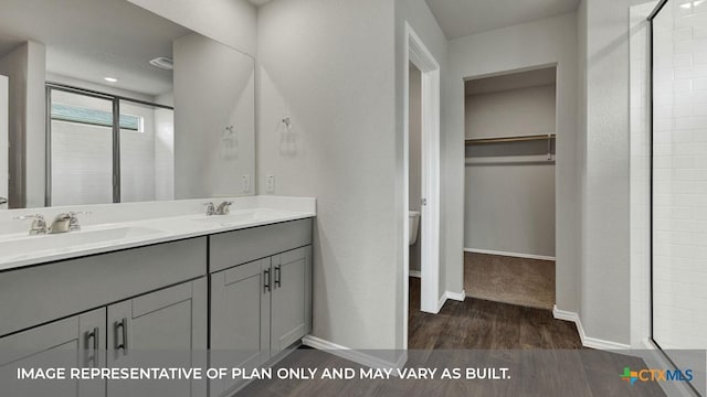 bathroom with vanity, hardwood / wood-style flooring, a shower with shower door, and toilet