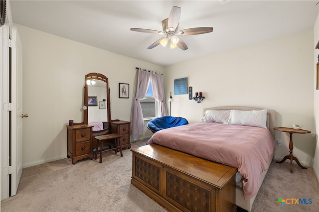 bedroom with ceiling fan and light carpet