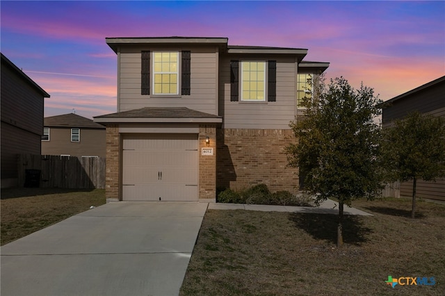 front facade featuring a garage and a lawn