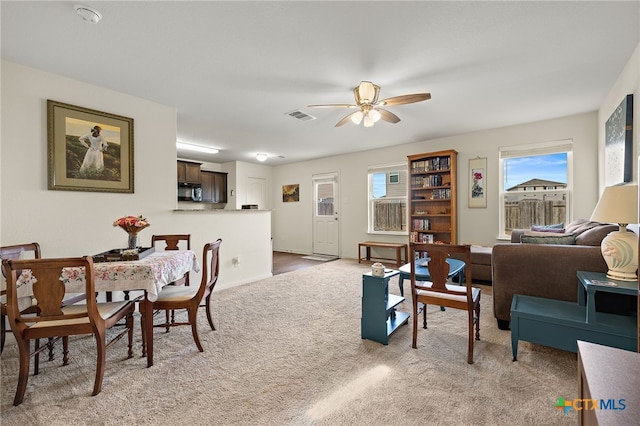 living room featuring ceiling fan and light carpet