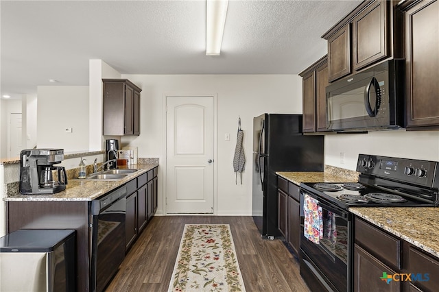 kitchen with dark hardwood / wood-style floors, black appliances, sink, dark brown cabinets, and light stone counters