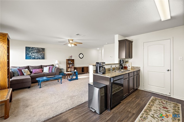 kitchen featuring light stone countertops, black dishwasher, sink, ceiling fan, and dark brown cabinets