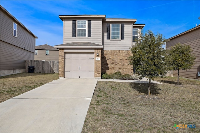 view of property featuring a front lawn and a garage