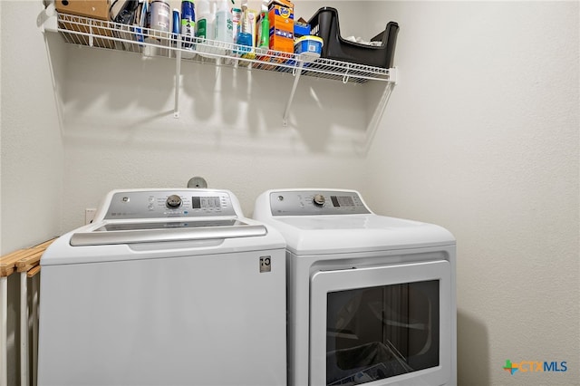 washroom featuring washing machine and dryer