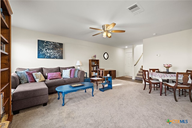 carpeted living room featuring ceiling fan