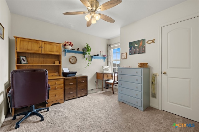 home office with light carpet and ceiling fan