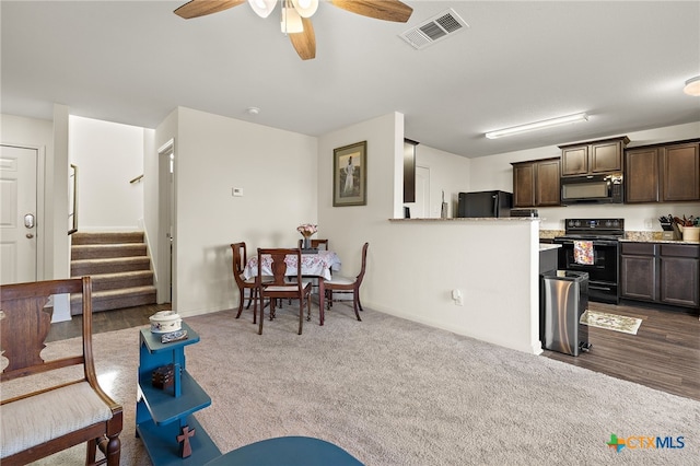 carpeted living room featuring ceiling fan