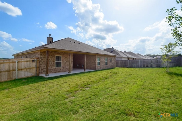 1010 Winchester Dr, Nolanville, TX 76559 - back of house featuring a patio area, a fenced backyard, brick siding, and a chimney