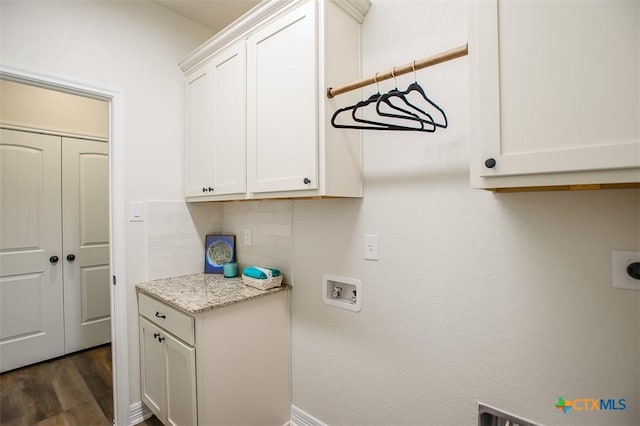 1010 Winchester Dr, Nolanville, TX 76559 - laundry room with cabinet space, washer hookup, hookup for an electric dryer, and dark wood-style flooring
