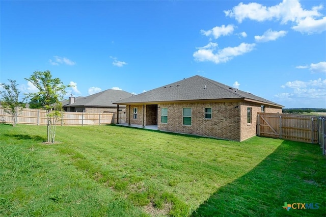 1010 Winchester Dr, Nolanville, TX 76559 - back of house featuring brick siding, a fenced backyard, a patio, and roof with shingles