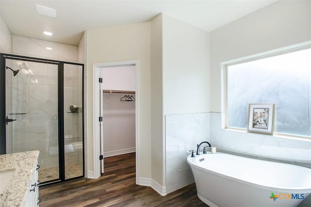 1010 Winchester Dr, Nolanville, TX 76559 - full bath with a freestanding bath, a stall shower, a spacious closet, wood finished floors, and vanity