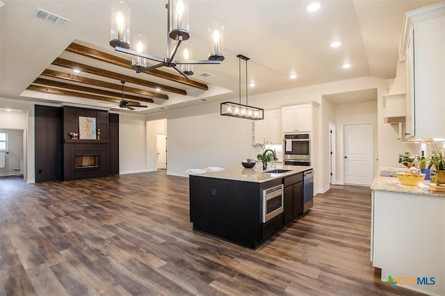 1010 Winchester Dr, Nolanville, TX 76559 - kitchen with a fireplace, ceiling fan, dishwasher, dark wood-type flooring, and recessed lighting