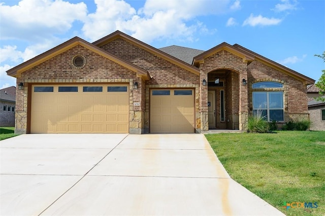 1010 Winchester Dr, Nolanville, TX 76559 - french provincial home with brick siding, an attached garage, and concrete driveway