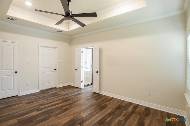 1010 Winchester Dr, Nolanville, TX 76559 - unfurnished bedroom featuring a tray ceiling, dark wood-style floors, ornamental molding, and ceiling fan