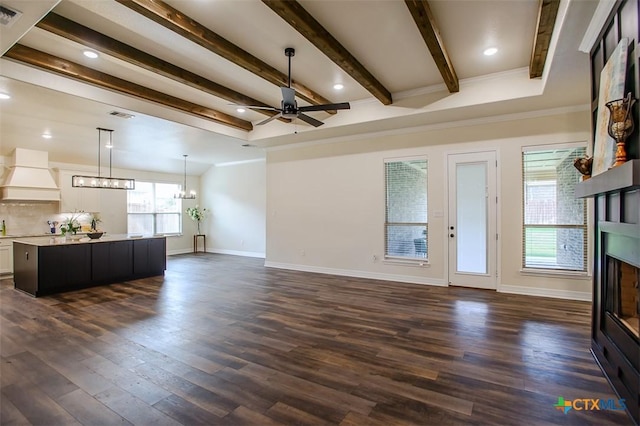 1010 Winchester Dr, Nolanville, TX 76559 - unfurnished living room featuring a fireplace, a chandelier, a ceiling fan, dark wood-style flooring, and beamed ceiling