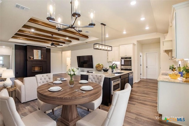 1010 Winchester Dr, Nolanville, TX 76559 - dining space with ceiling fan, wood finished floors, a chandelier, a fireplace, and recessed lighting