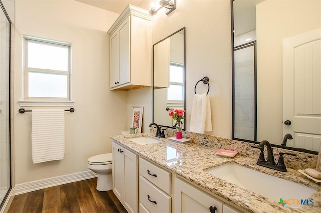 1010 Winchester Dr, Nolanville, TX 76559 - full bathroom with an enclosed shower, wood finished floors, and double vanity