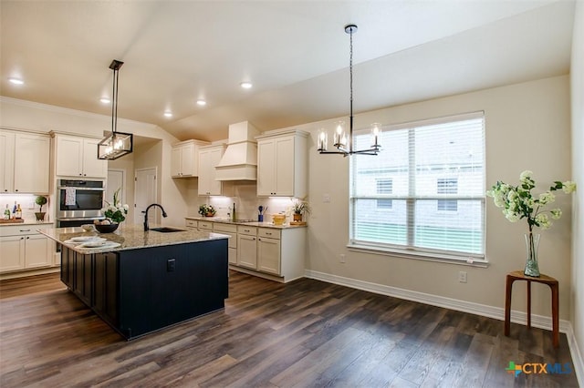 1010 Winchester Dr, Nolanville, TX 76559 - kitchen featuring custom range hood, a chandelier, backsplash, dark wood-style flooring, and light stone countertops