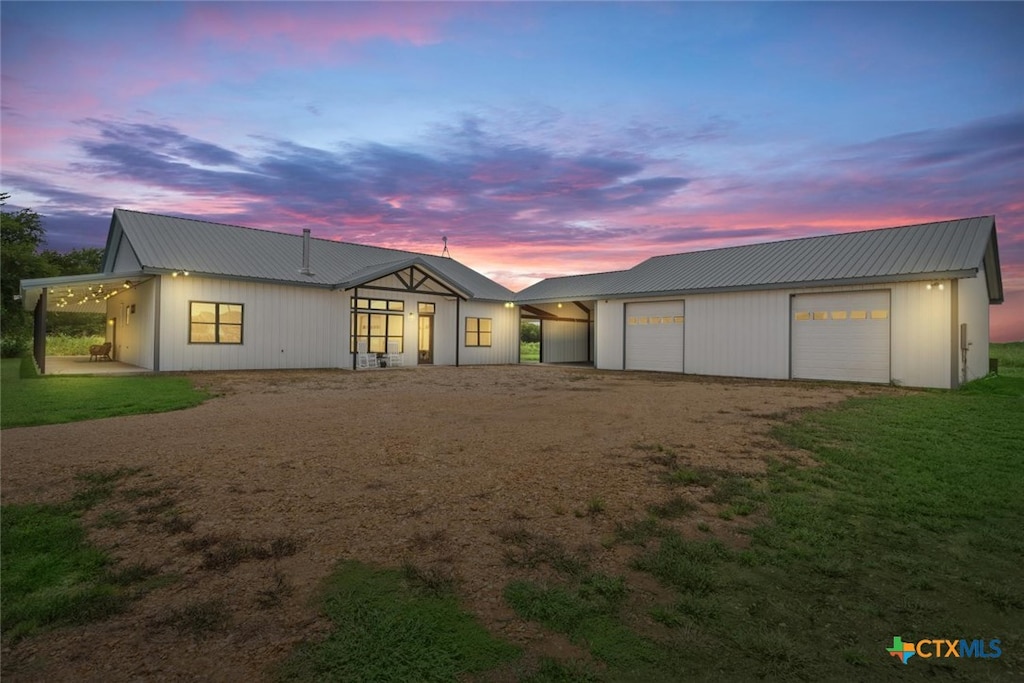 view of front of house featuring a garage and a patio area