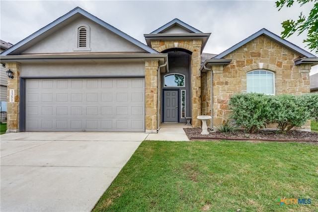 view of front of home with a front lawn and a garage