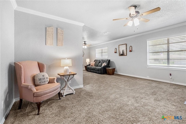 living area featuring baseboards, a ceiling fan, crown molding, and carpet