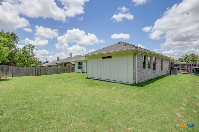 exterior space featuring a yard and central AC unit