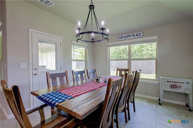 tiled dining area featuring a chandelier and plenty of natural light