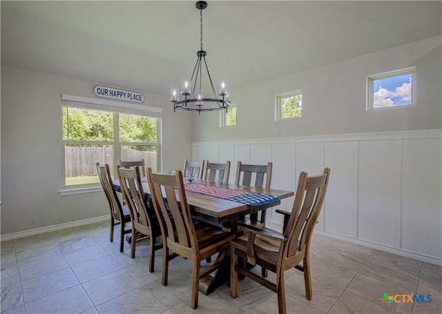 dining space with light tile patterned flooring and a chandelier