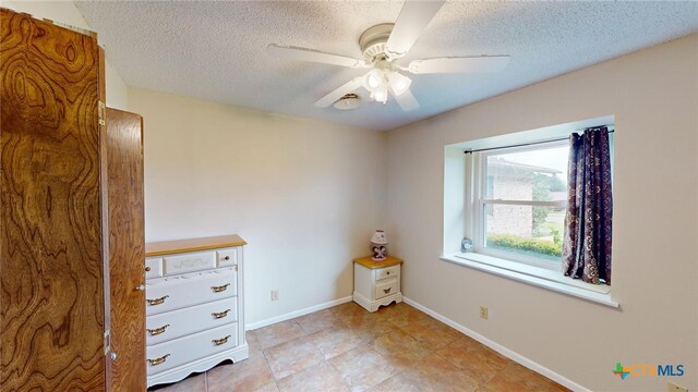 unfurnished bedroom with a textured ceiling and ceiling fan